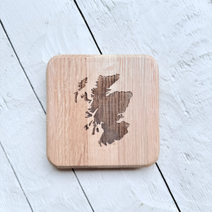 Barrel Oak Wooden coaster with laser-cut Scotland map design on a light wooden surface